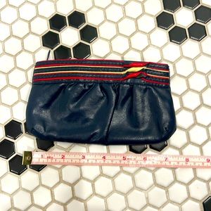 Vintage navy coin purse with red and cream detailing.